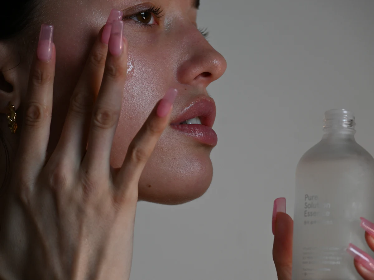 Pressing serum into the cheek with fingertips